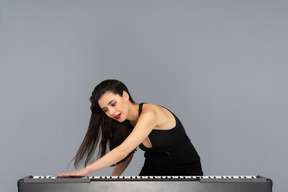 Passionate female pianist swiping piano keys