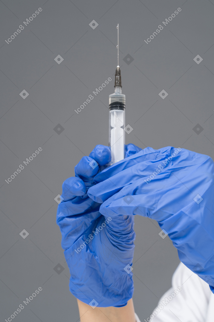 Human hands holding medical syringe