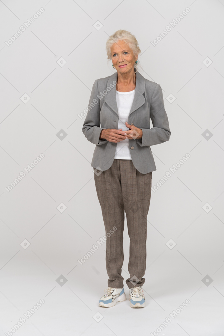 Front view of a happy old lady in suit