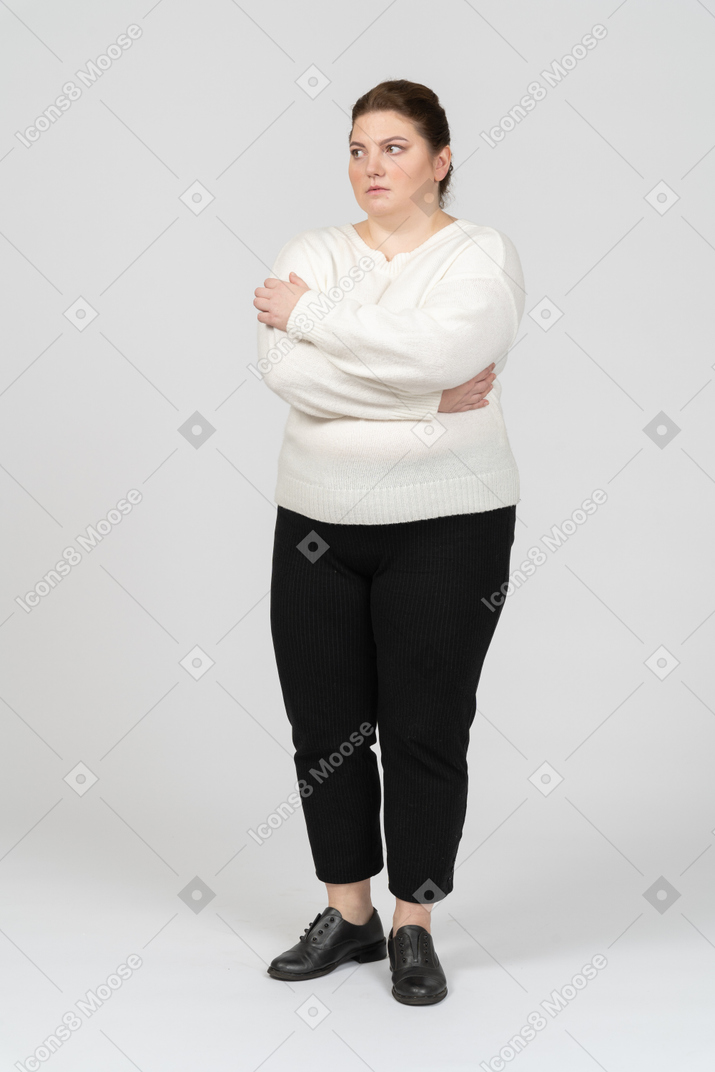 Mujer regordeta en ropa casual manteniendo los brazos cruzados