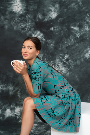 Jeune femme en robe bleue pendant la pause-café