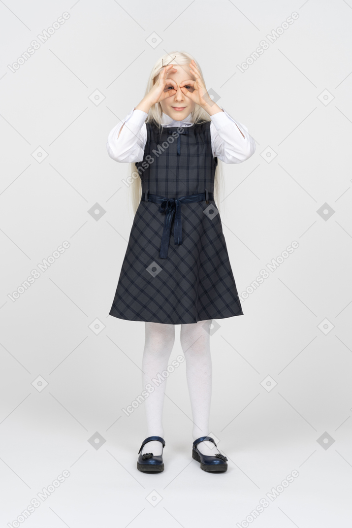 Schoolgirl making hand binoculars