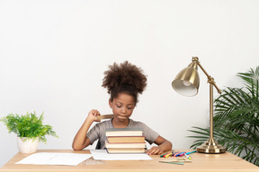 Good looking cute girl with books at the table