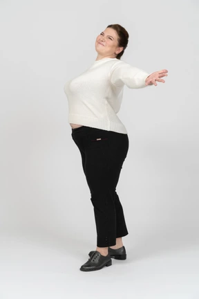 Happy plump woman in casual clothes posing