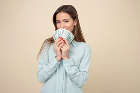 Attractive woman holding dollar bills