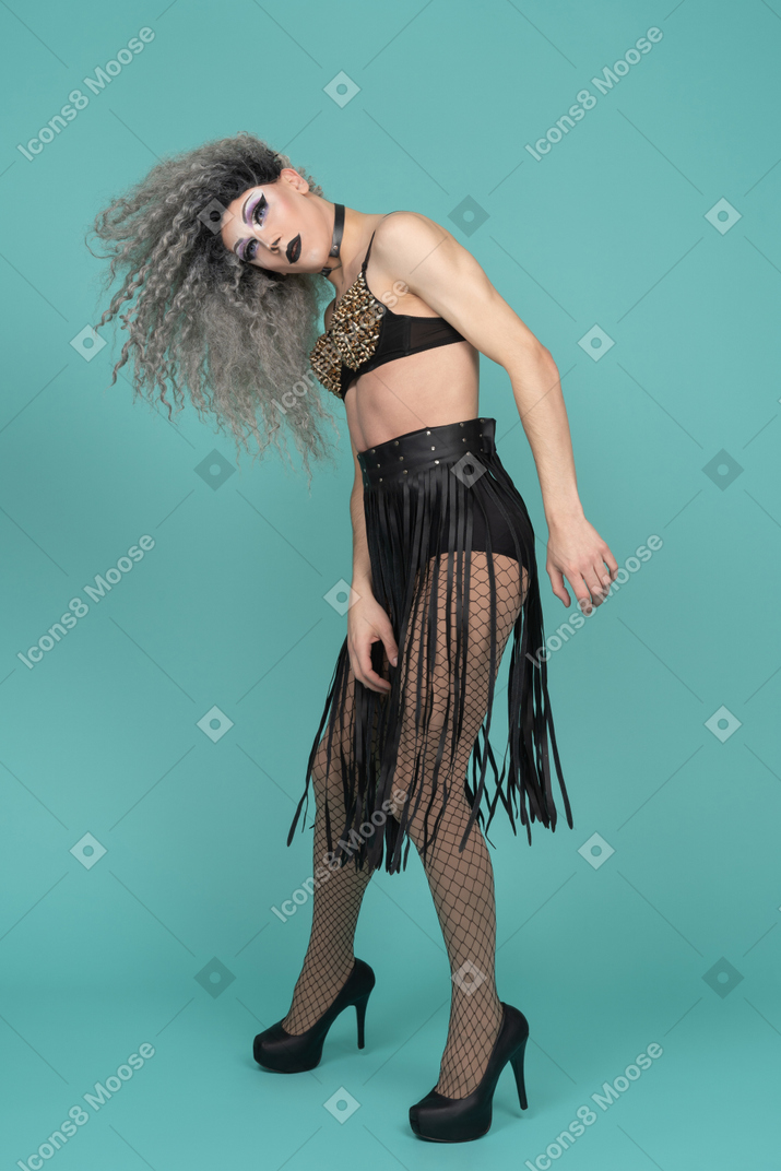 Drag queen in all black outfit shaking their hair