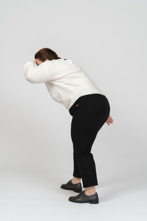 Side view of plus size woman in casual clothes looking for someone