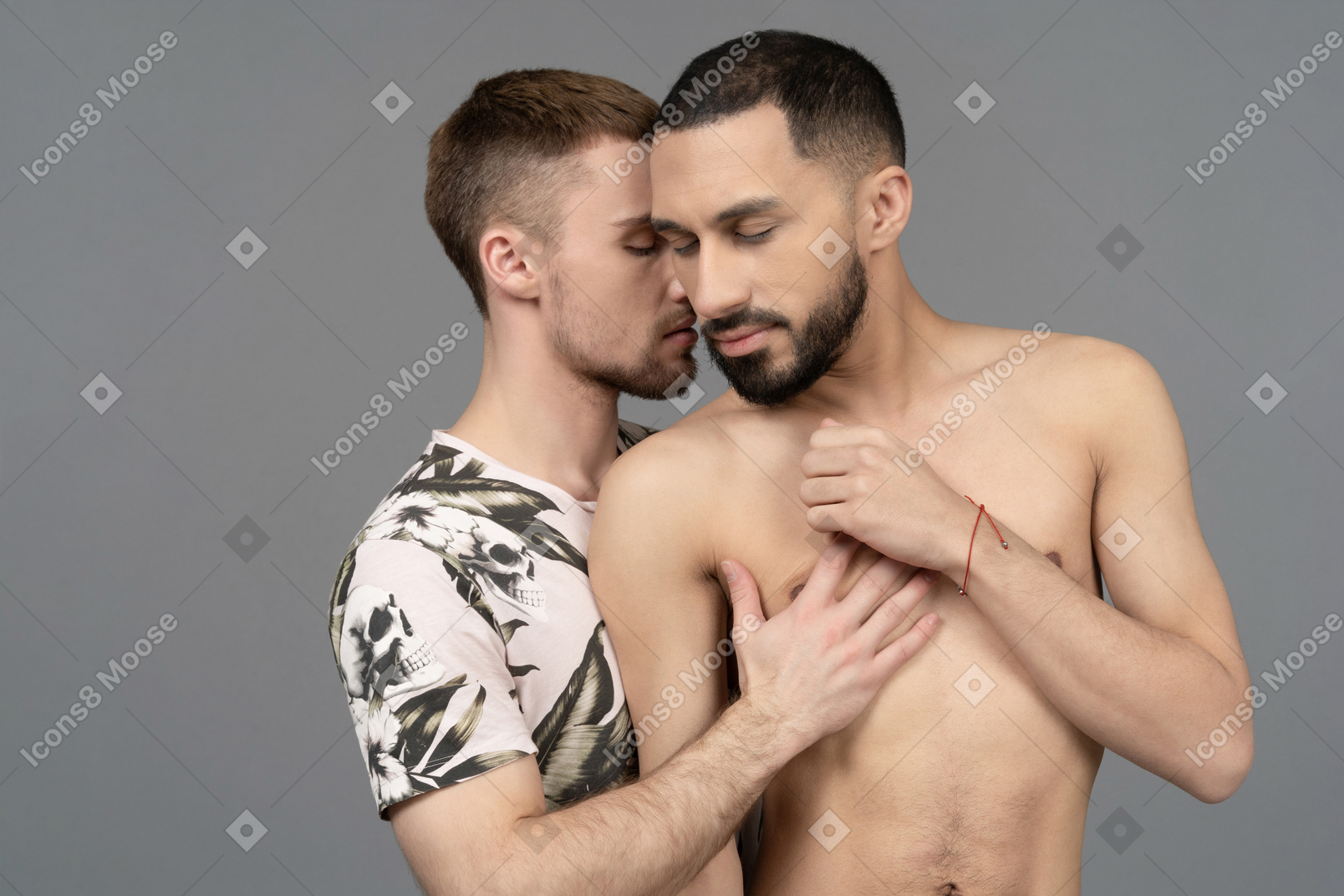 Close-up of a young caucasian man half-hugging his lover sensually