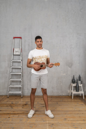 Front view of a man playing ukulele
