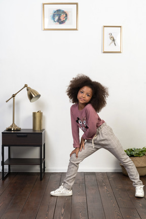 Cute girl kid posing on the apartments background