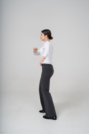 Side view of a woman in suit dancing