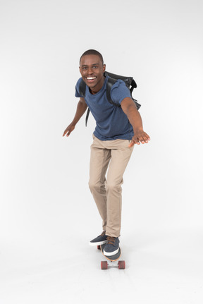 City male tourist standing on skateboard