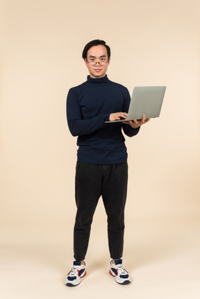 Young asian man presenting a laptop