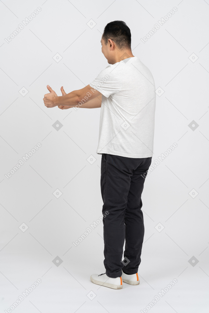 Side view of a happy man showing thumbs up