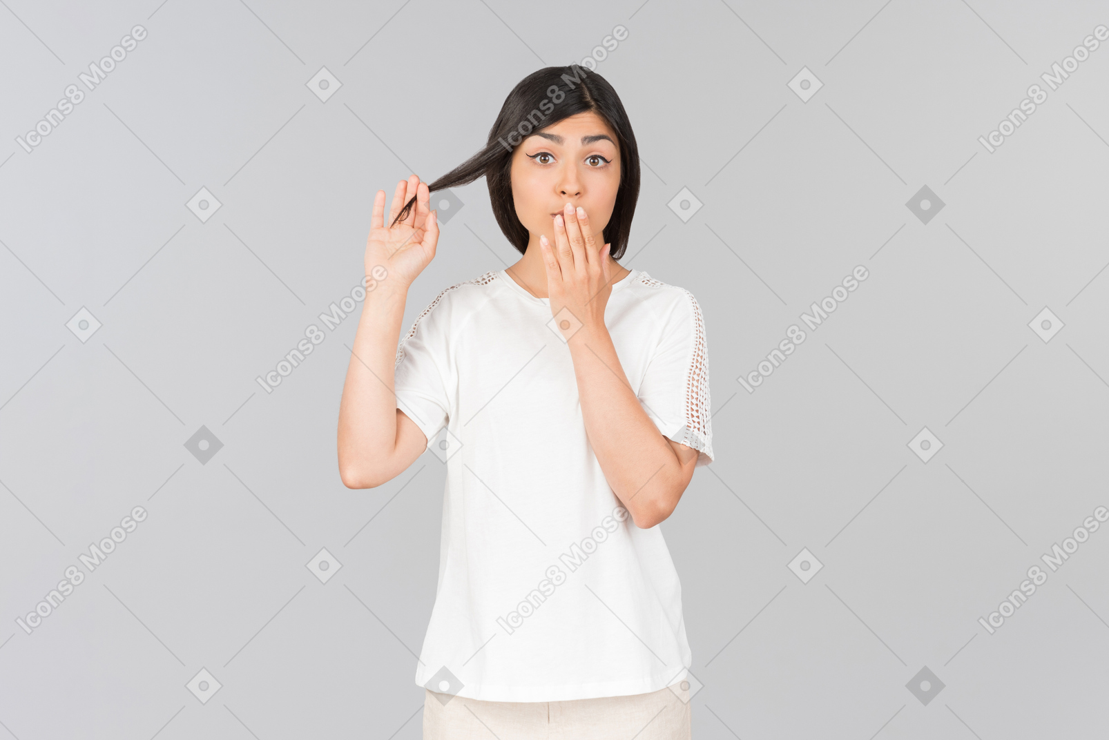 Surprised young indian woman closing mouth with a hand