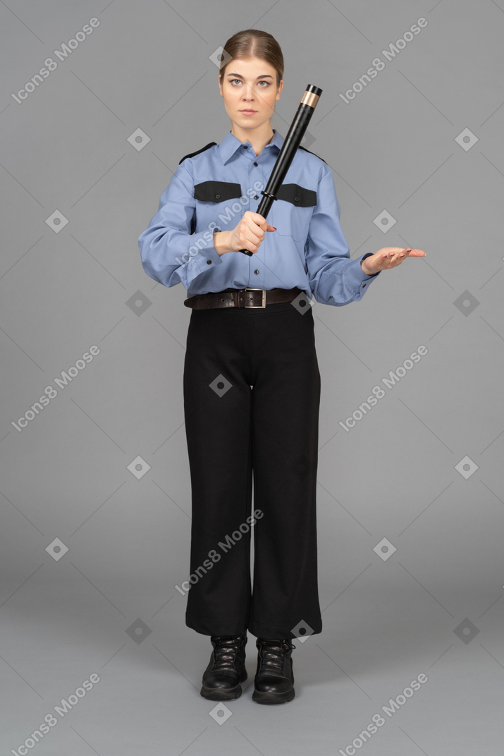 Female security guard with a baton in hands