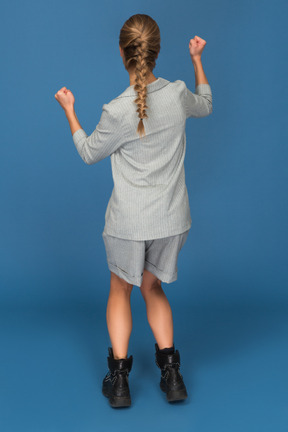 Back view of a young woman celebrating