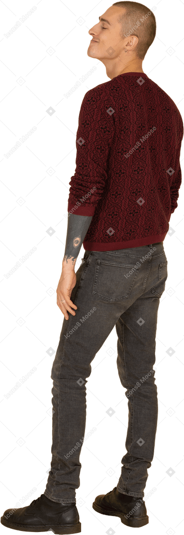 Three-quarter back view of a funny grimacing young man in read sweater