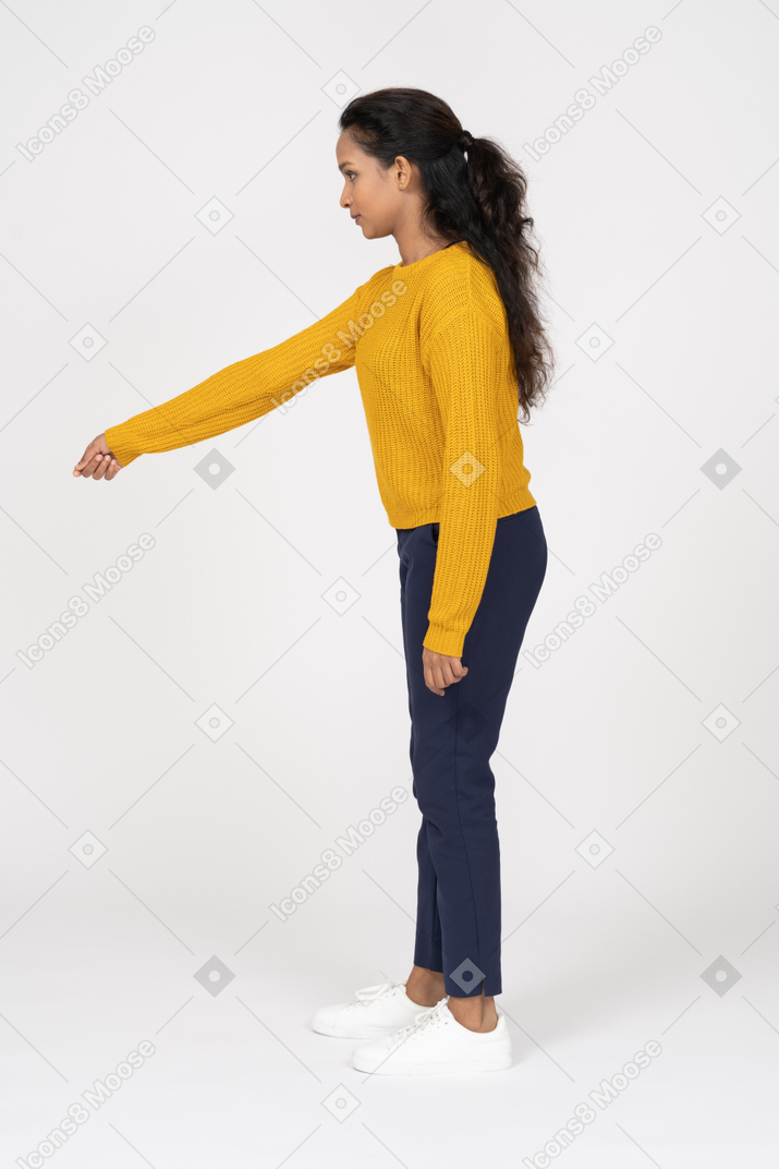Side view of a girl in casual clothes pointing at something