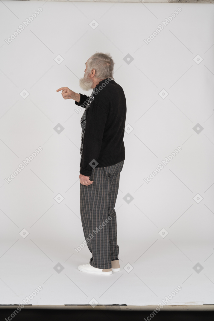 Side view of old man showing index finger