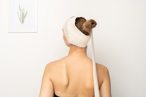 Back view of a female patient with bandaged head