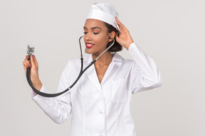 Attractive young female doctor holding a stethoscope