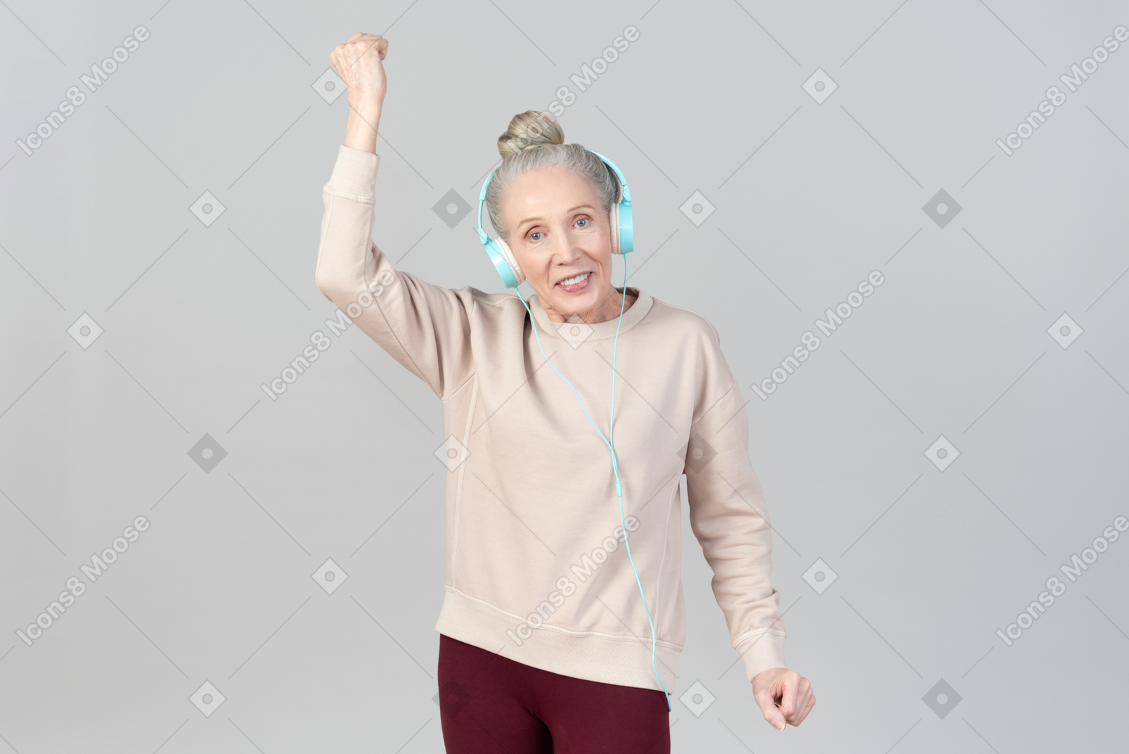 Joyful young lady in headphones dancing to music