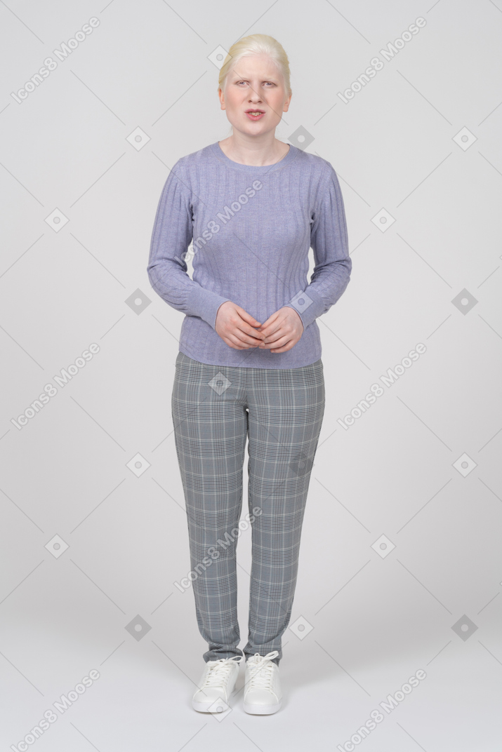 Confused woman in casual clothes standing