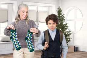 Disappointed boy received his christmas gift from grandmother