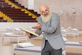 A man with a long beard holding a book