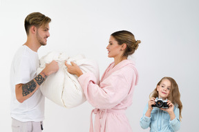 Little girl taking photos of her parents