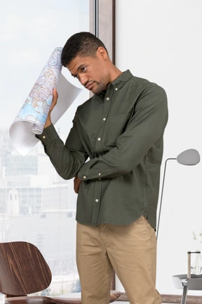 Thoughtful man holding a big paper map