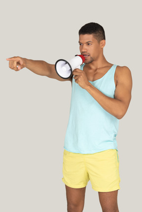 Man holding a megaphone and pointing forward