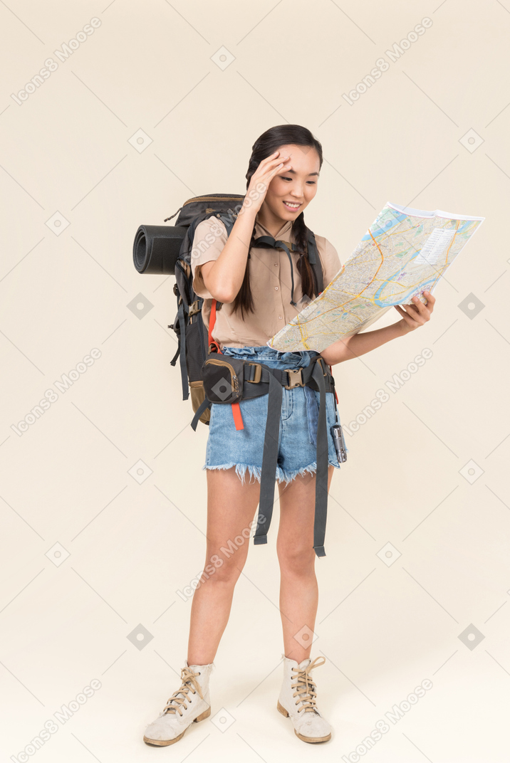 Young asian hiker is happy to understand where she is