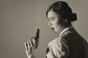 Female detective with a gun in profile