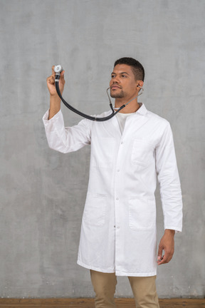 Male doctor using a stethoscope