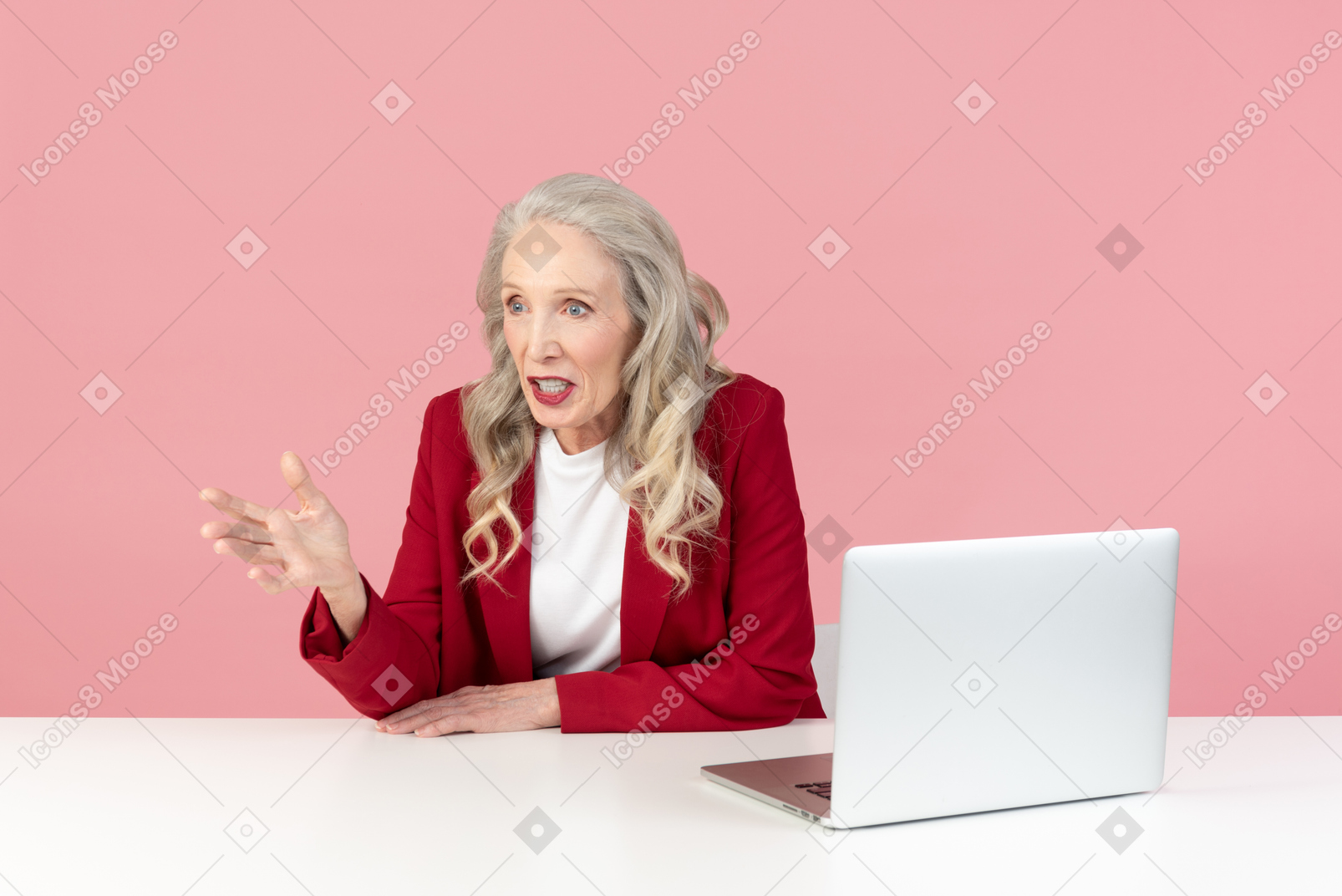 Aged woman sitting at the table and seems like talking to someone