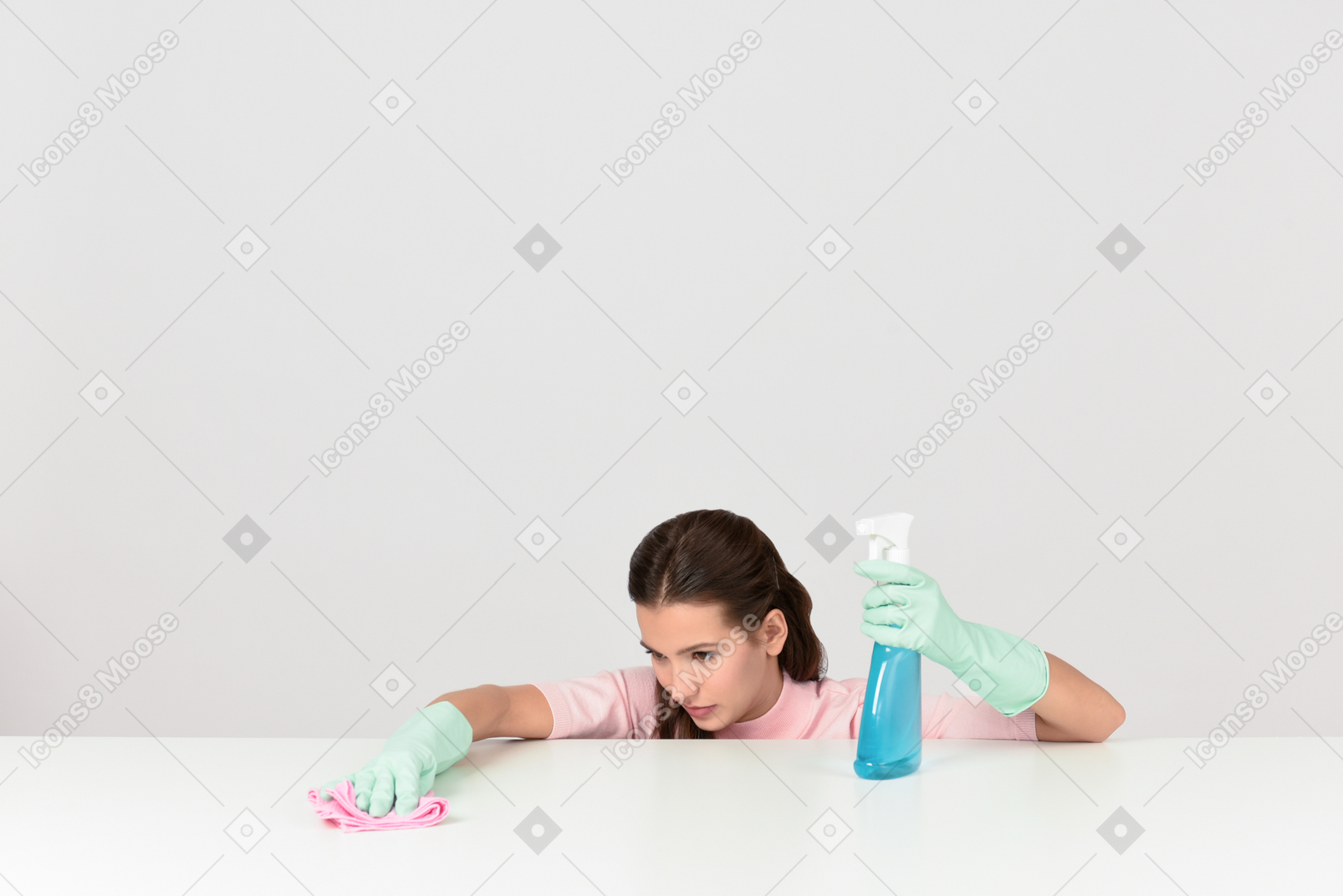 Attractive young woman dusting a surface