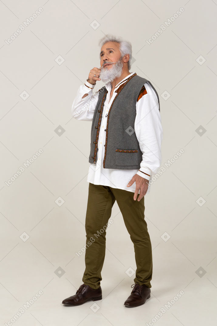 Man in casual clothes twisting his moustache