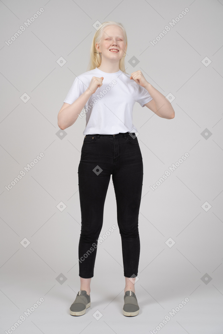 Young woman smiling with her fists up