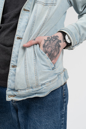 Close-up of tattooed hand in pocket