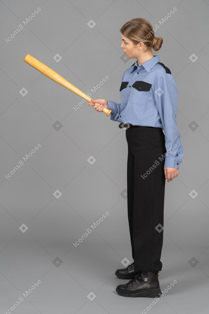 Female security guard pointing with a baseball bat