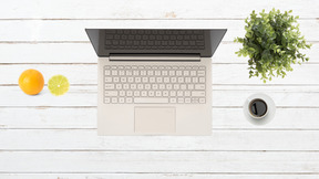 A laptop computer sitting on top of a white table