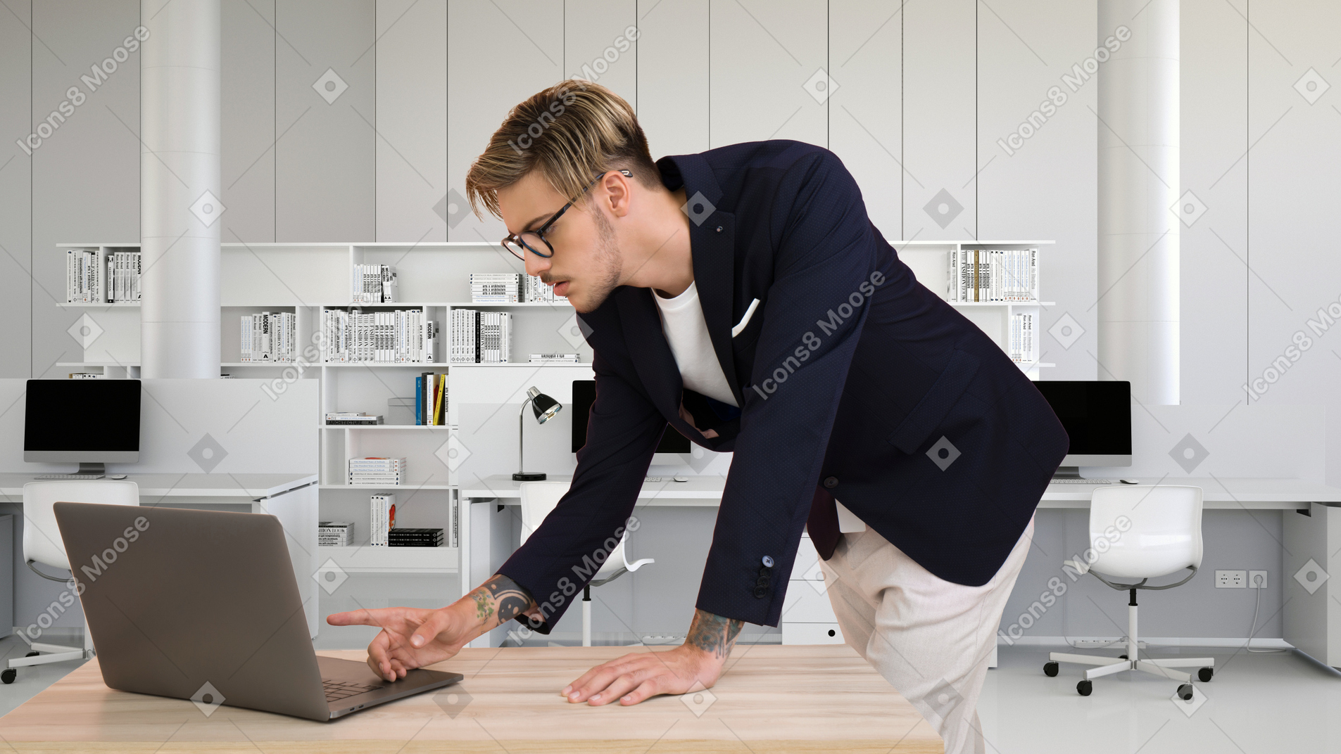 A businessman leaning over a desk and using a laptop