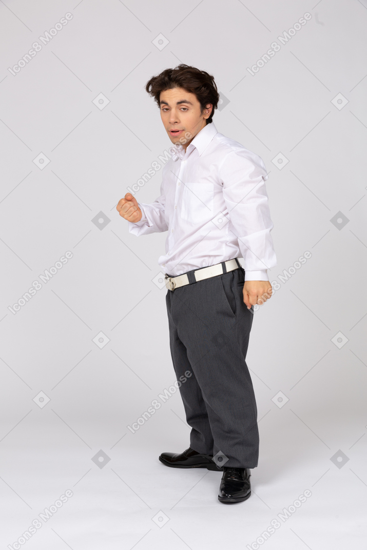 Side view of rude businessman threatening with fist