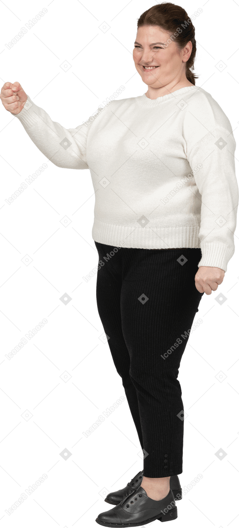 Happy plus size woman in white sweater posing