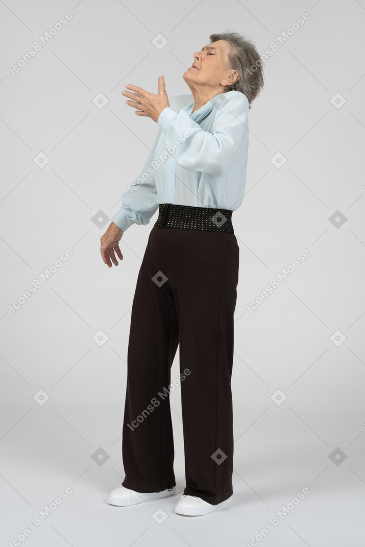 Old lady with closed eyes gesturing