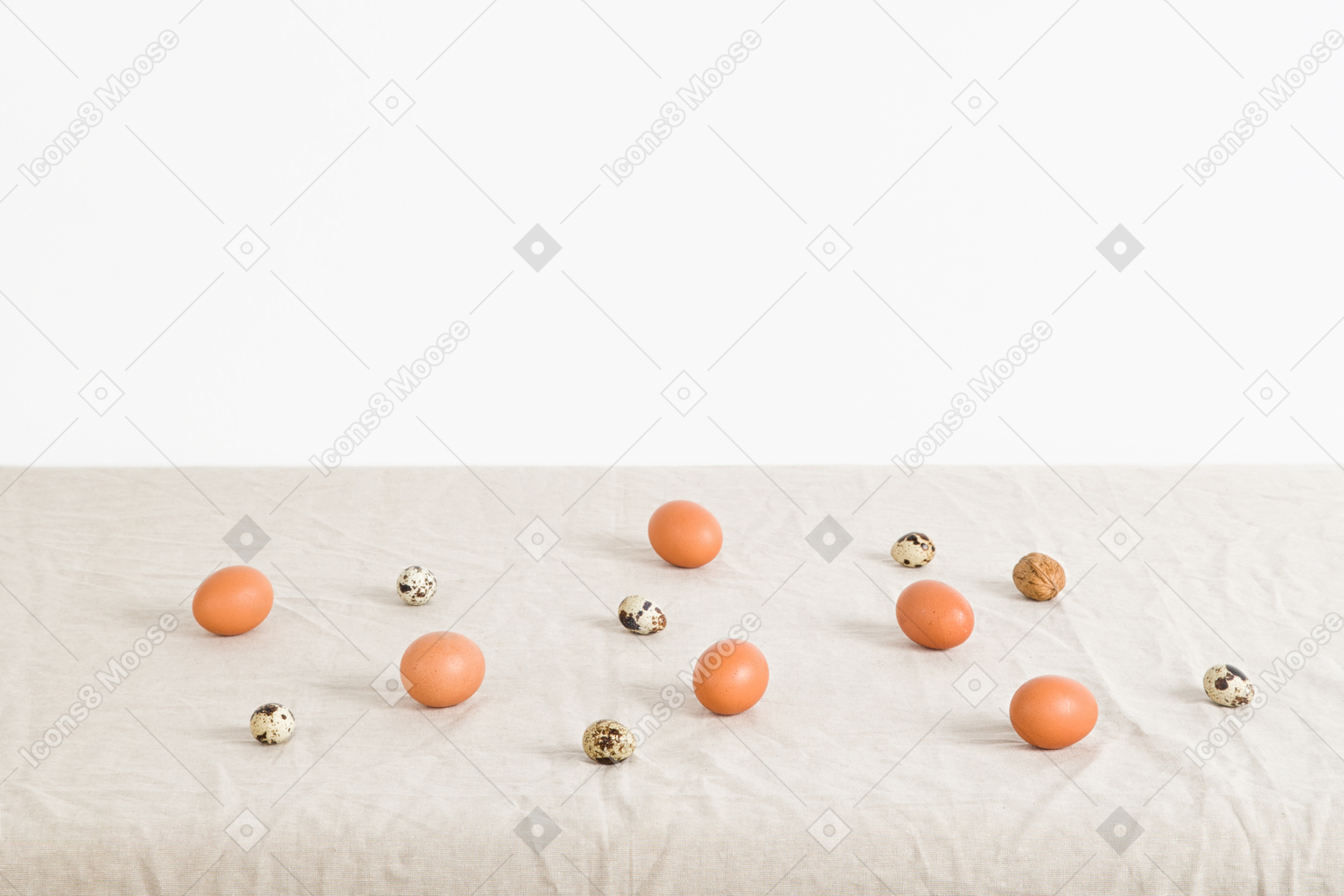 Chicken and quail eggs on a white tablecloth