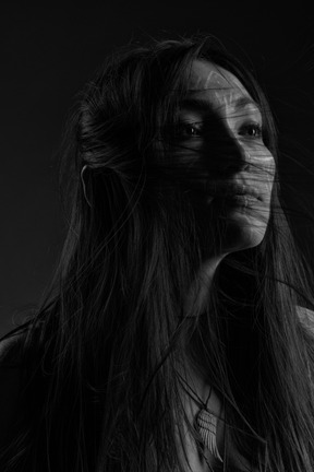 A black and white photo of a woman with long hair