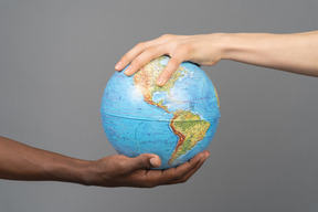 Earth globe in two different hands